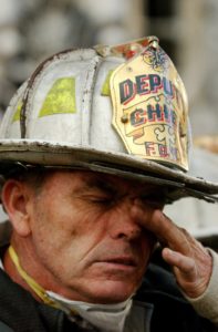 Fireman helping after 9/11 attack in NYC. Image by David Mark from Pixabay.