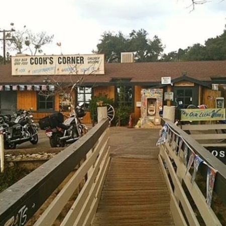 Photo showing the front of the Cook's Corner building and sign.