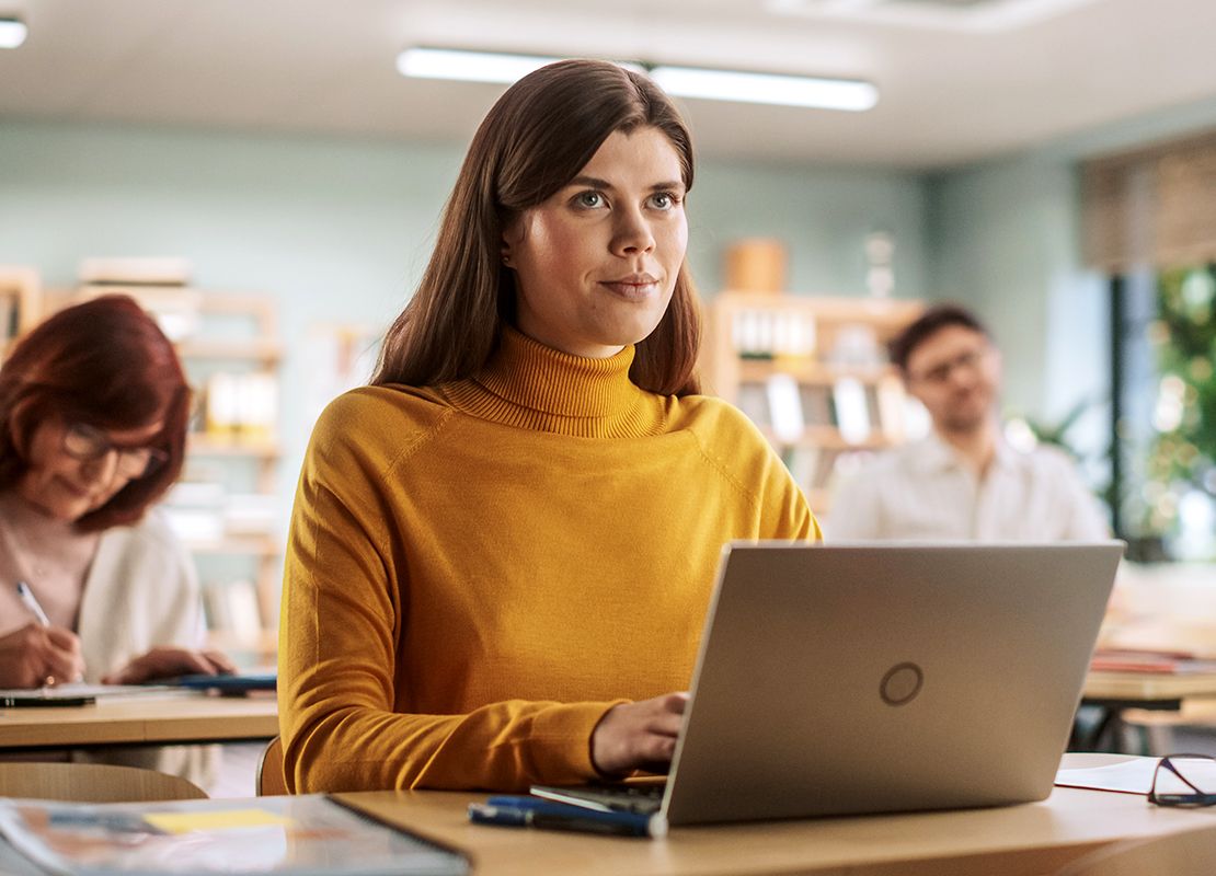 Woman on laptop in classroom