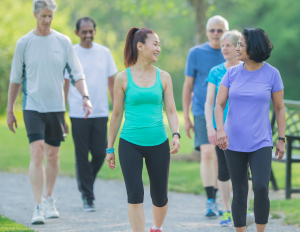 Group of people walking outdoors in a park.