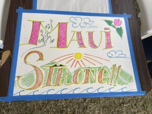 Drawing by a child that reads Maui Strong with flowers, mountains and sun.